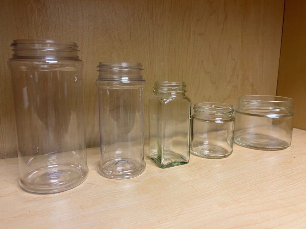 a group of glass jars 
