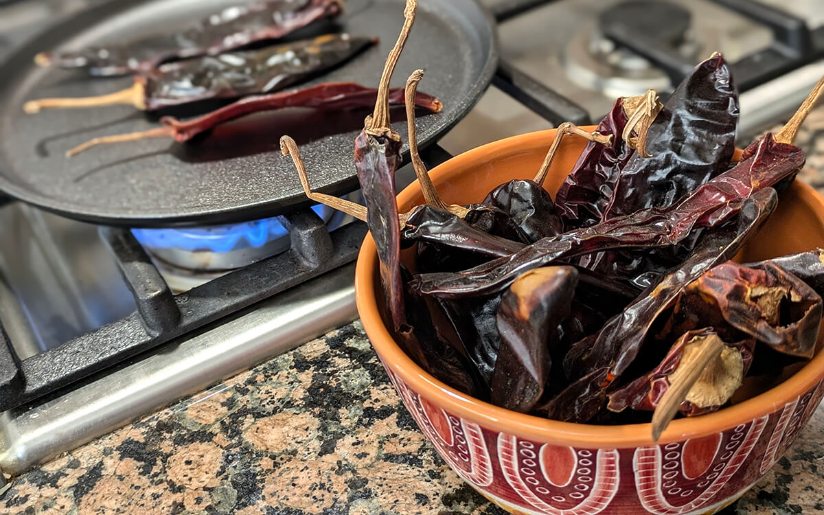 dried guajillo peppers on a comal
