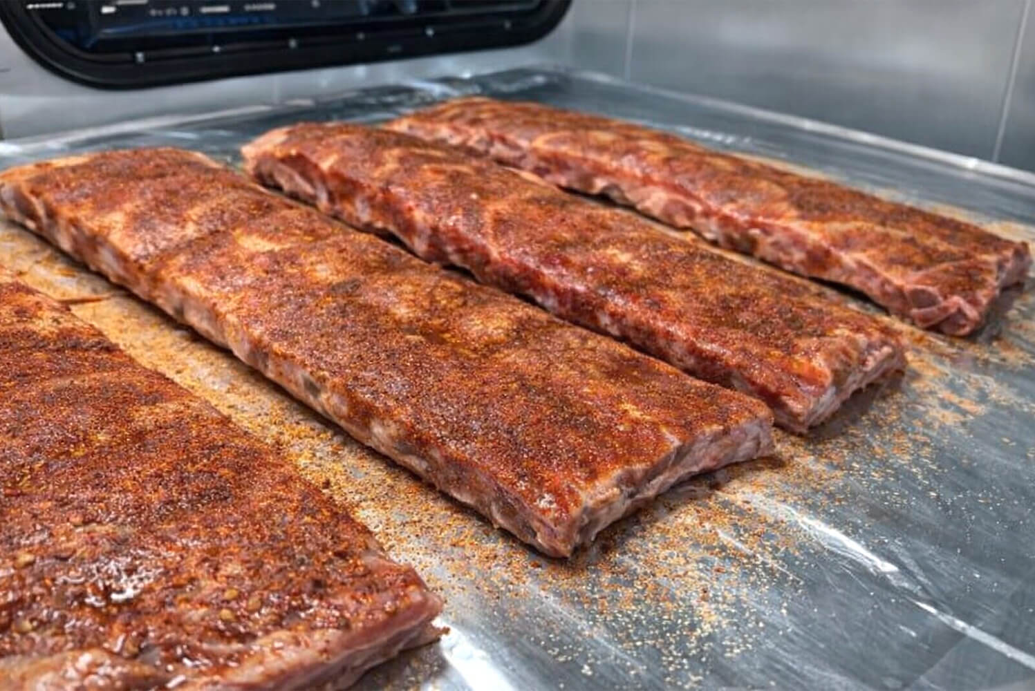 ribs covered in bbq seasoning before the smoking process