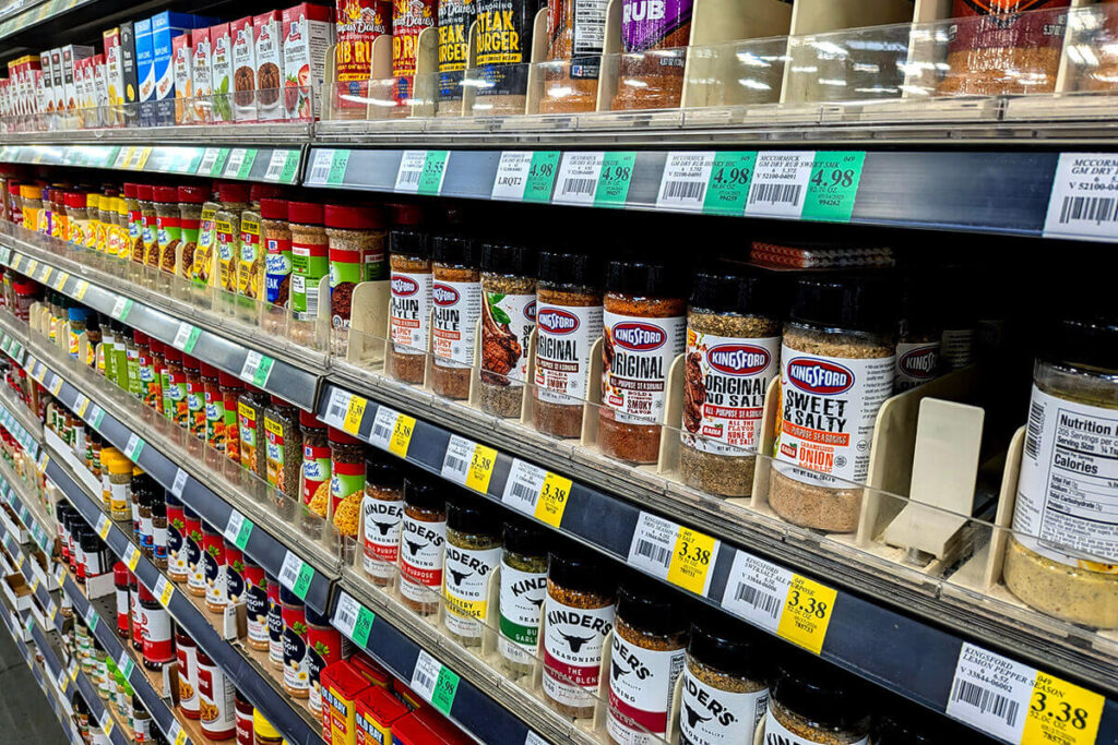 Private Label vs. Custom Blend Spices - a selection of private label spice bottle in grocery store aisle