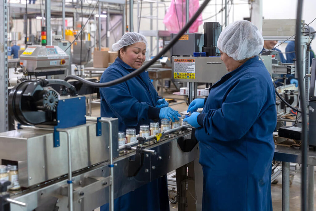 Women working on private label production line at Vanns Spices